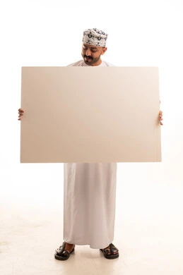 Omani Man in Traditional Dress Holding Blank White Board