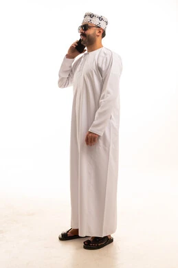 Omani Man in Traditional Dress on Smartphone