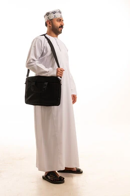 Omani Man Wearing Traditional Dishdasha with Laptop Bag