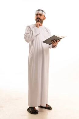 Omani Man in Traditional Dress Reading a Book
