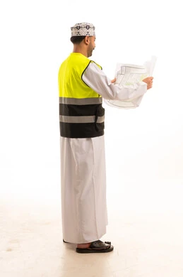 Omani Engineer with Blueprints Wearing Safety Vest