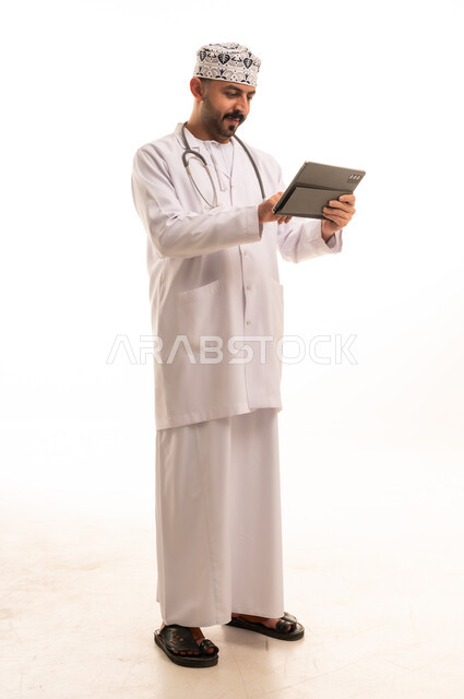 Omani Male Doctor Using Digital Tablet