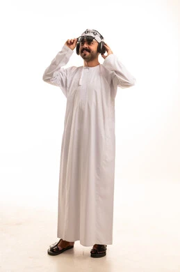 Omani Man in Traditional White Dishdasha with Headphones