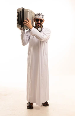 Omani Man in Traditional Dress Carrying Suitcase