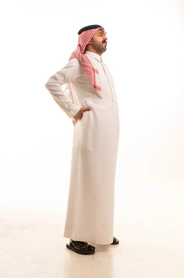 Saudi Man in Traditional Thobe Experiencing Back Pain