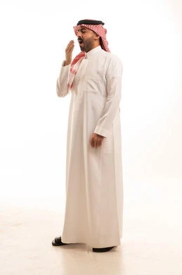 Saudi Man in Traditional Dress Yawning on White Background