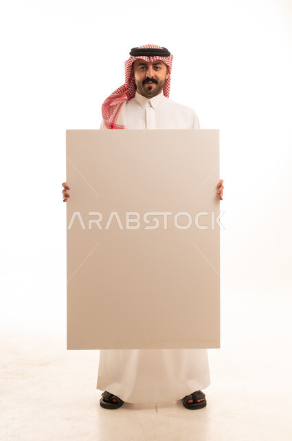 Saudi Man in Traditional Dress Holding Blank White Board