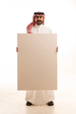 Saudi Man in Traditional Dress Holding Blank White Board
