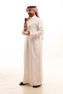 Saudi Man in Traditional Thobe Speaking with Microphone