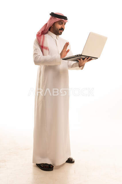 Saudi Man in Thobe Using Laptop Video Call