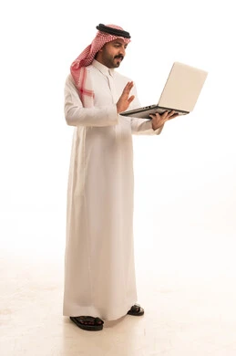 Saudi Man in Thobe Using Laptop Video Call