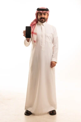 Saudi Man in Traditional Thobe Holding Smartphone