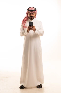 Saudi Man in Thobe Using Smartphone on White Background