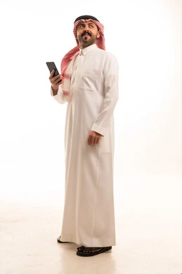 Saudi Man in Traditional Thobe Holding a Smartphone