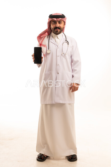 Saudi Doctor Holding Smartphone in Studio