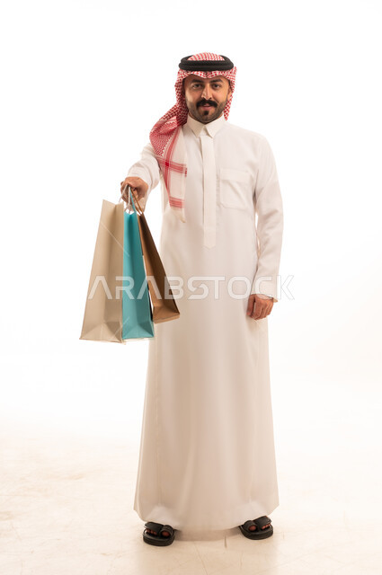 Saudi Man Holding Shopping Bags in Studio