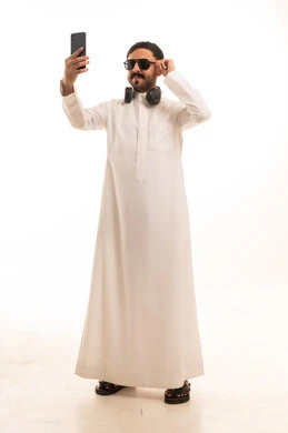 Saudi Man Taking Selfie in Traditional Thobe and Sunglasses