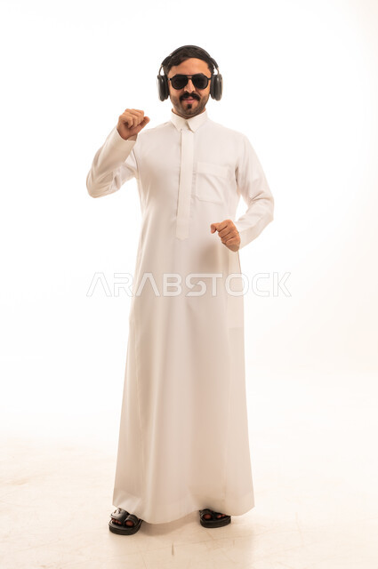 Saudi Man in Thobe with Headphones Dancing