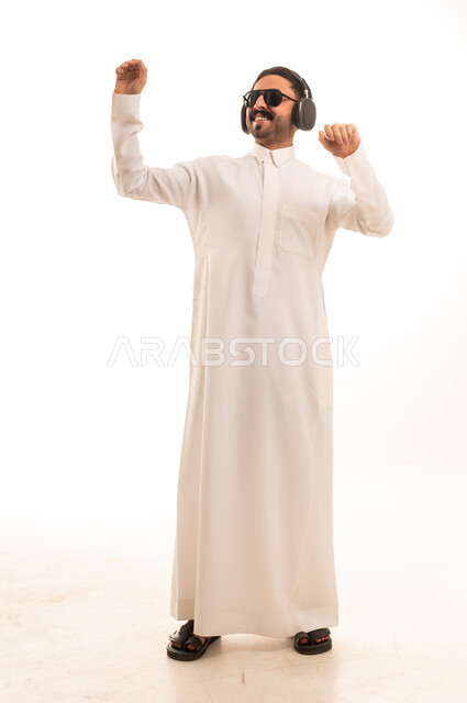 Saudi Man in White Thobe Dancing with Headphones