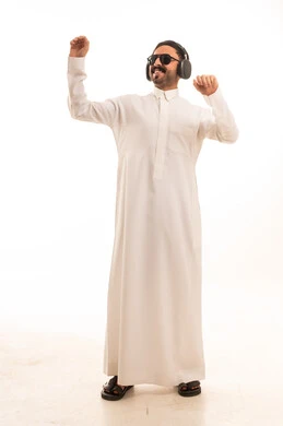 Saudi Man in White Thobe Dancing with Headphones