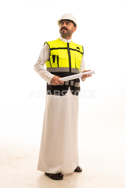 Saudi Engineer in Thobe and Safety Vest Holding Blueprint