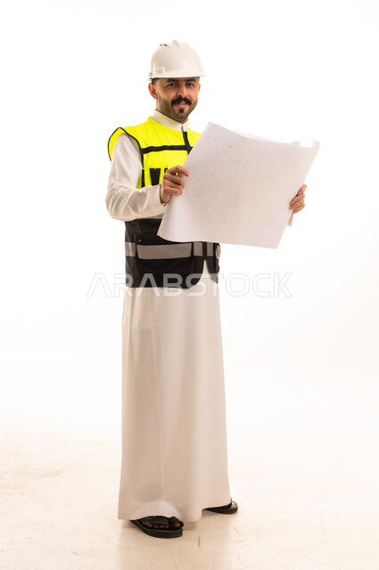 Saudi Engineer in Thobe Holding Construction Blueprint