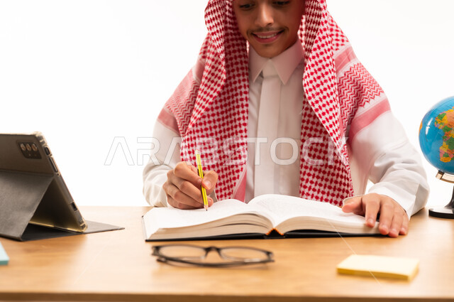 Saudi Student in Traditional Thobe Writing at Desk