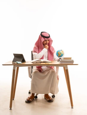 Saudi Man at Desk with World Globe