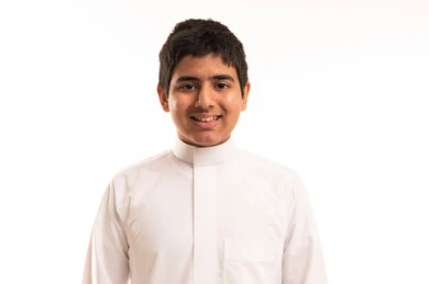 Smiling Saudi Boy in Traditional White Thobe