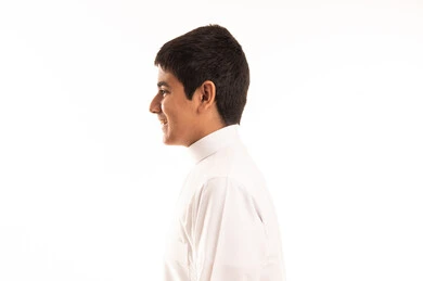 Saudi Boy in Traditional White Thobe Side Profile