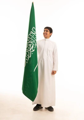 Saudi Boy with National Flag in Traditional Thobe