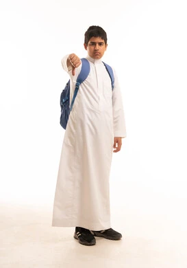Saudi Boy in Thobe Giving Thumbs Down Gesture