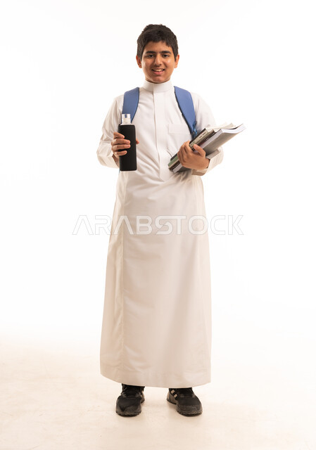 Saudi Student in White Thobe Holding School Supplies