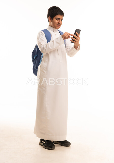 Saudi Student in White Thobe with Backpack and Phone