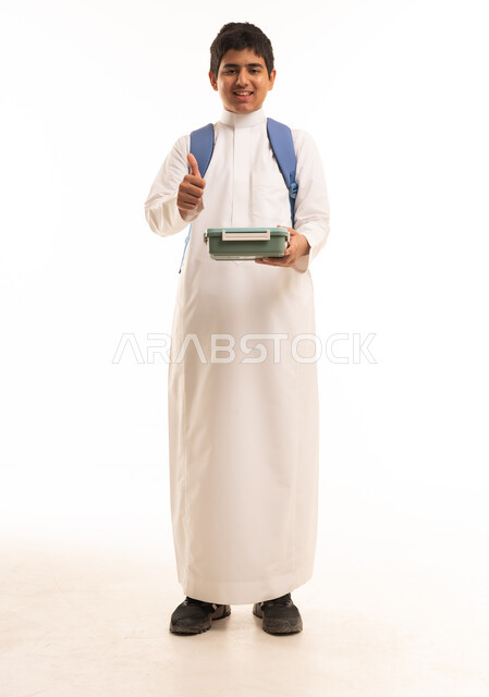 Saudi Schoolboy in Thobe with Lunchbox and Backpack