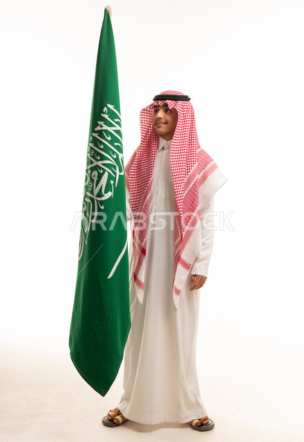 Saudi Boy Holding National Flag in Traditional Dress