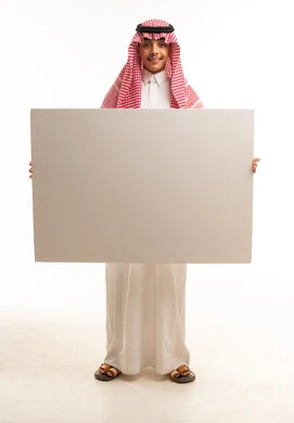 شاب سعودي يحمل لوحة إعلانية بيضاء فارغة