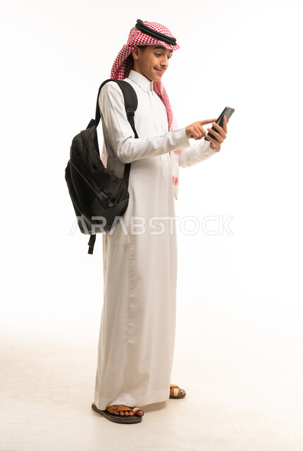 Saudi Male Student Using Smartphone with Backpack