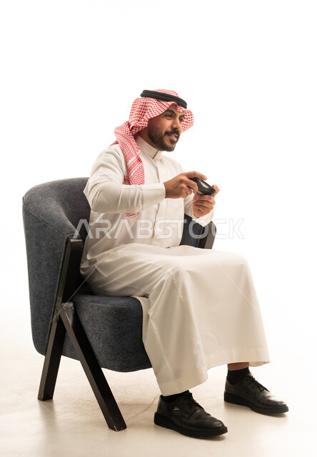 Saudi Man Playing Video Games in Traditional Thobe