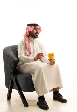 Saudi Man in Traditional Thobe Holding Popcorn