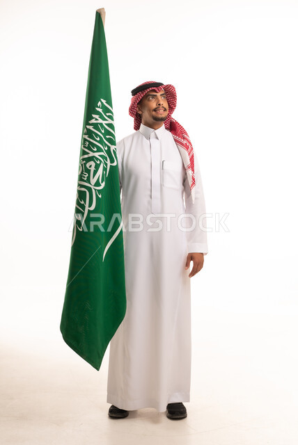 Saudi Man in Traditional Dress Holding Saudi Flag