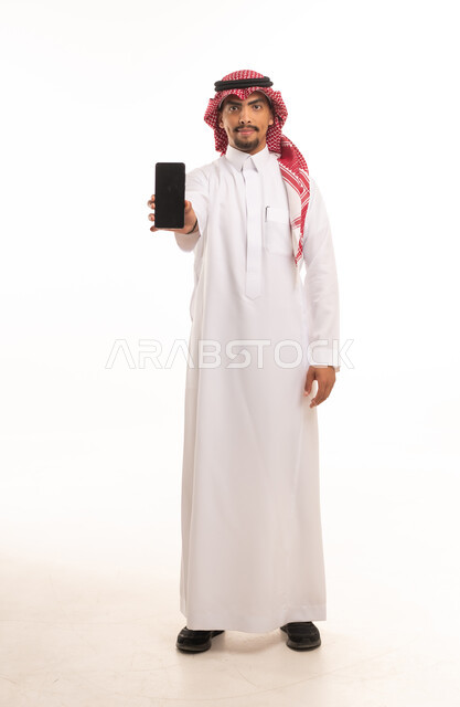 Saudi Man in Thobe Holding Smartphone White Background