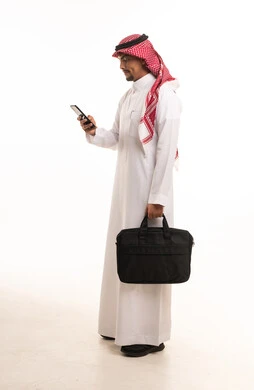 Saudi Businessman in Traditional Thobe Using Smartphone
