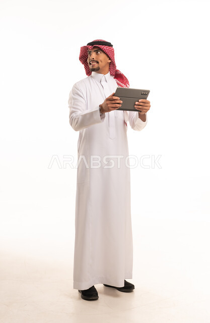 Saudi Man in Traditional Thobe Holding Digital Tablet