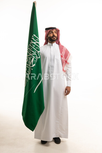 Saudi Man Holding National Flag in Traditional Dress