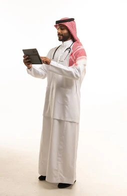 Saudi Male Doctor Using Tablet in Traditional Dress