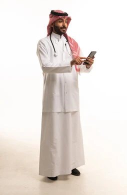 Saudi Doctor Using Smartphone on White Background
