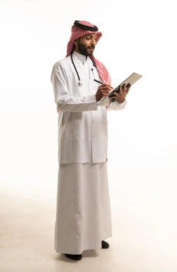 Saudi Male Doctor Writing on Clipboard White Background