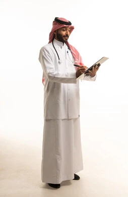 Saudi Male Doctor Writing on Medical Clipboard