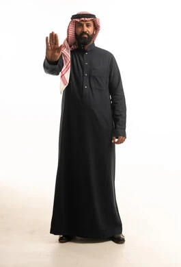 Saudi Man in Traditional Thobe Making Stop Gesture